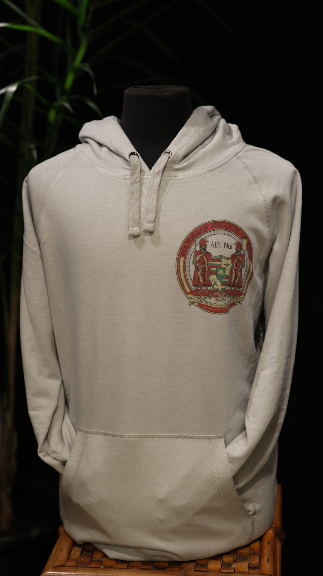 Light hoodie with a small crest printed on the left chest.